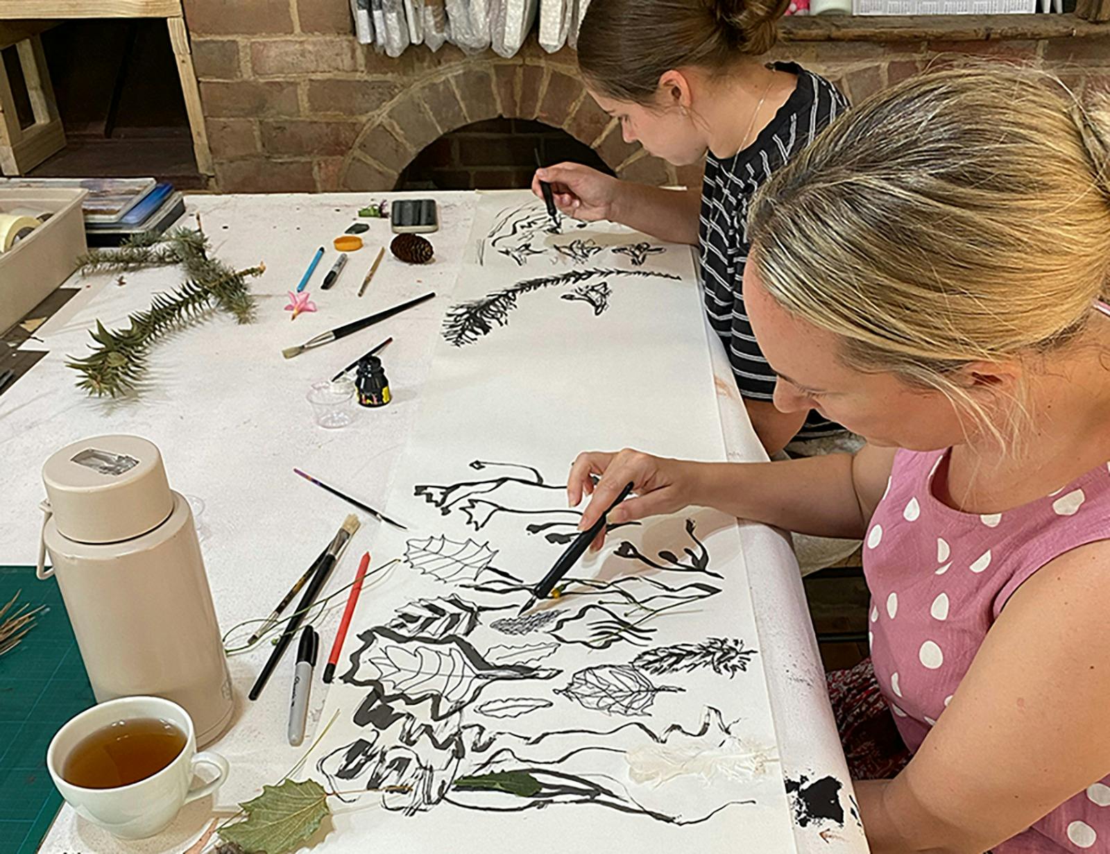 Two participants draw from natural forms during a hands-on workshop at Rogue Planet, Clunes.