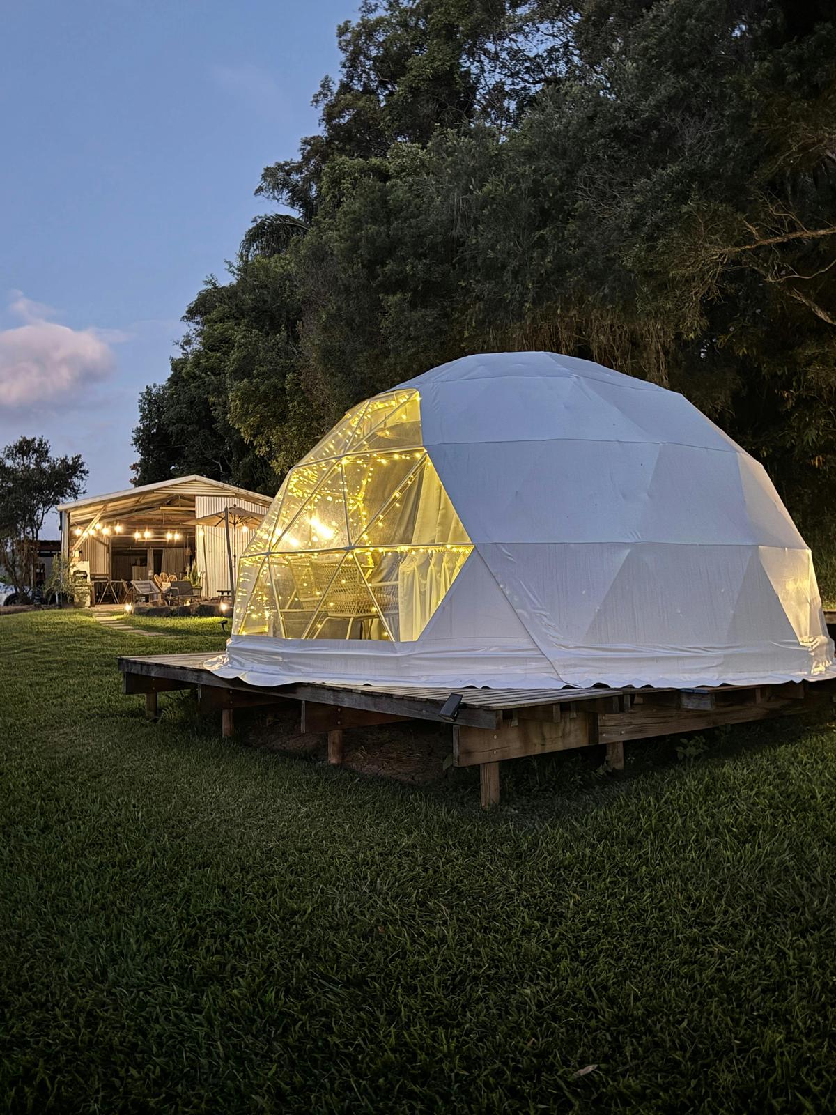 Our beautiful dome accomodation with guest barn in the background
