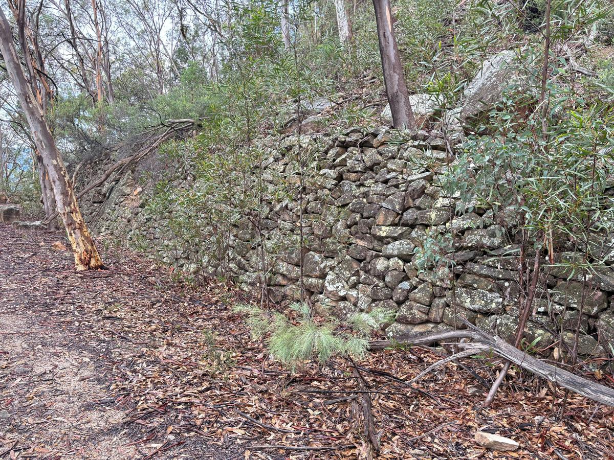 Hand built stone walls line the embankment of the 1907 Wolgan Valley Railway