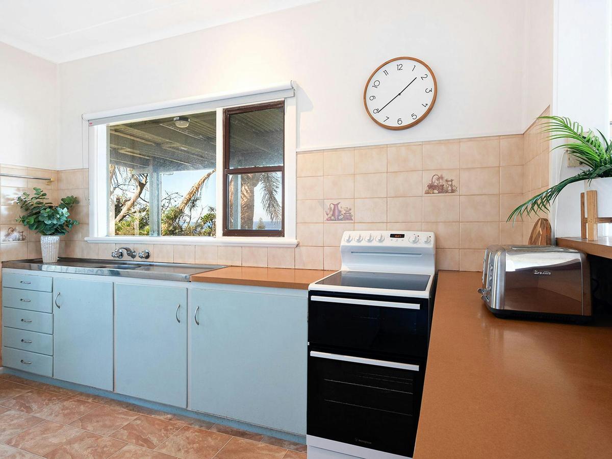 Fliptide House | Kitchen | Electric oven and stove top | Microwave | Refridgerator | Covered balcony