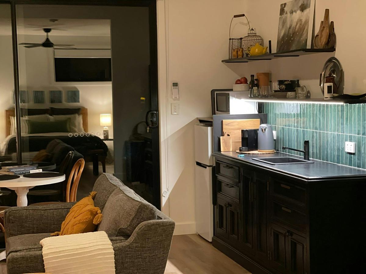 Kitchenette and living room are spacious and comfortable and features a wood burner.