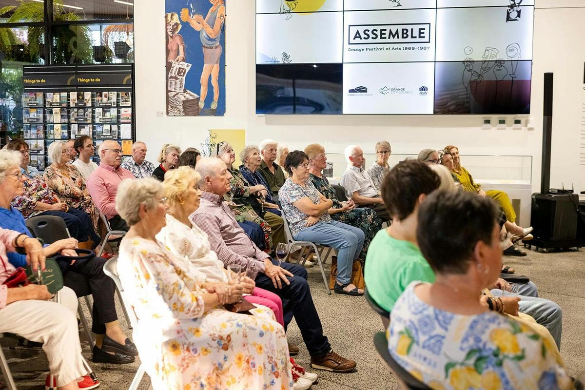 Visitors attend an exhibition opening at Orange Regional Museum