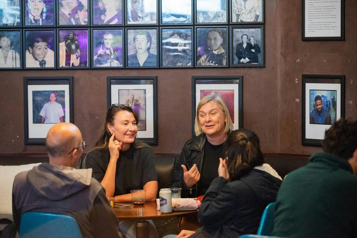 Visitors enjoying a social moment between live comedy sets at Comedy Store.