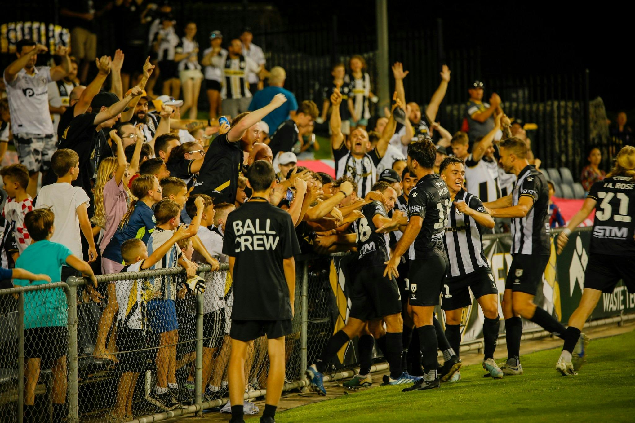 fans cheering in stadium for Macarthur Bulls FC team