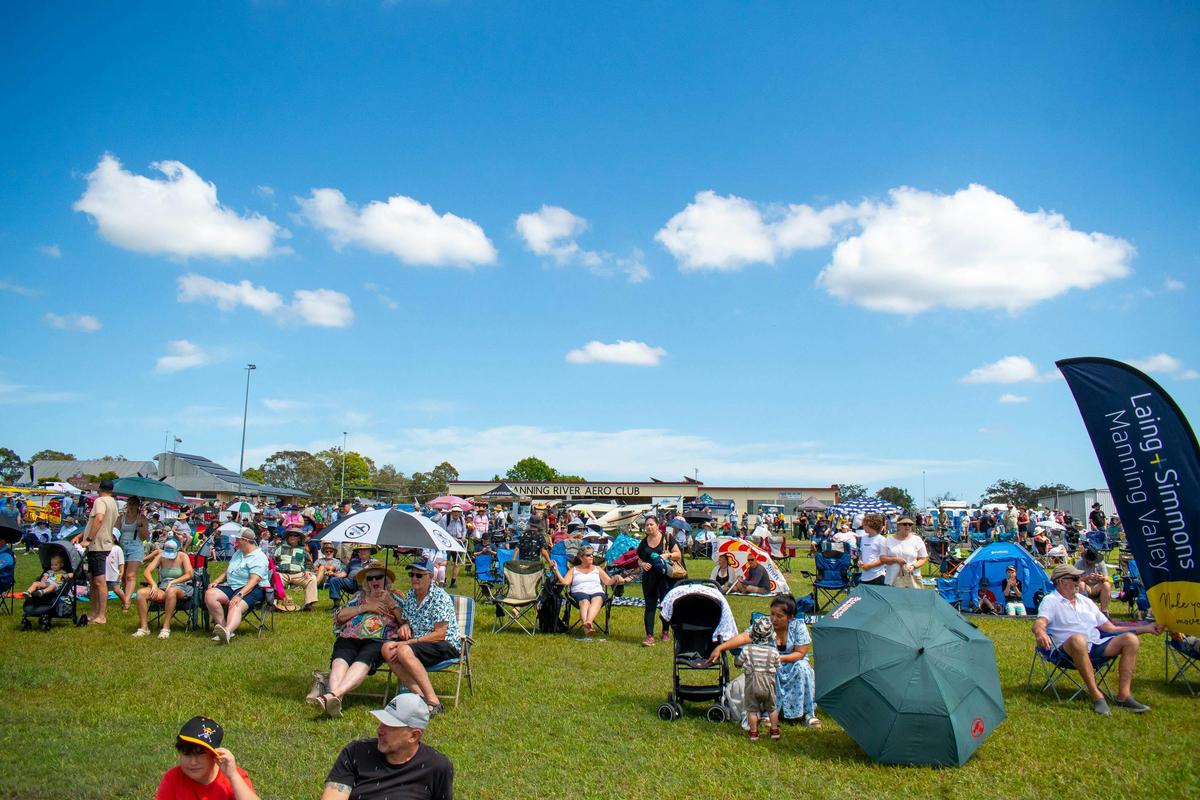 A large crowd gathers on the airfield lawn at Manning River Aero Club for Barrington Coast Airshow