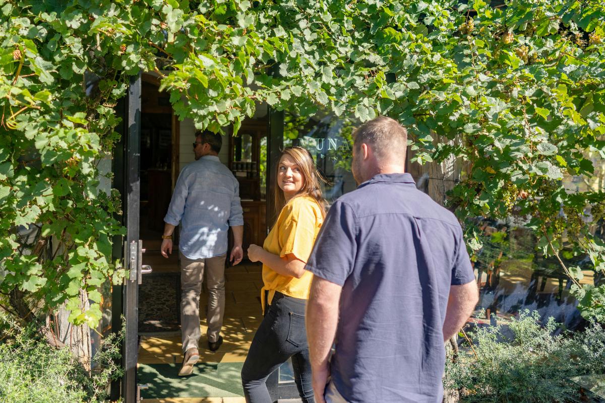 A young man and women entering the cellar door at munari wines