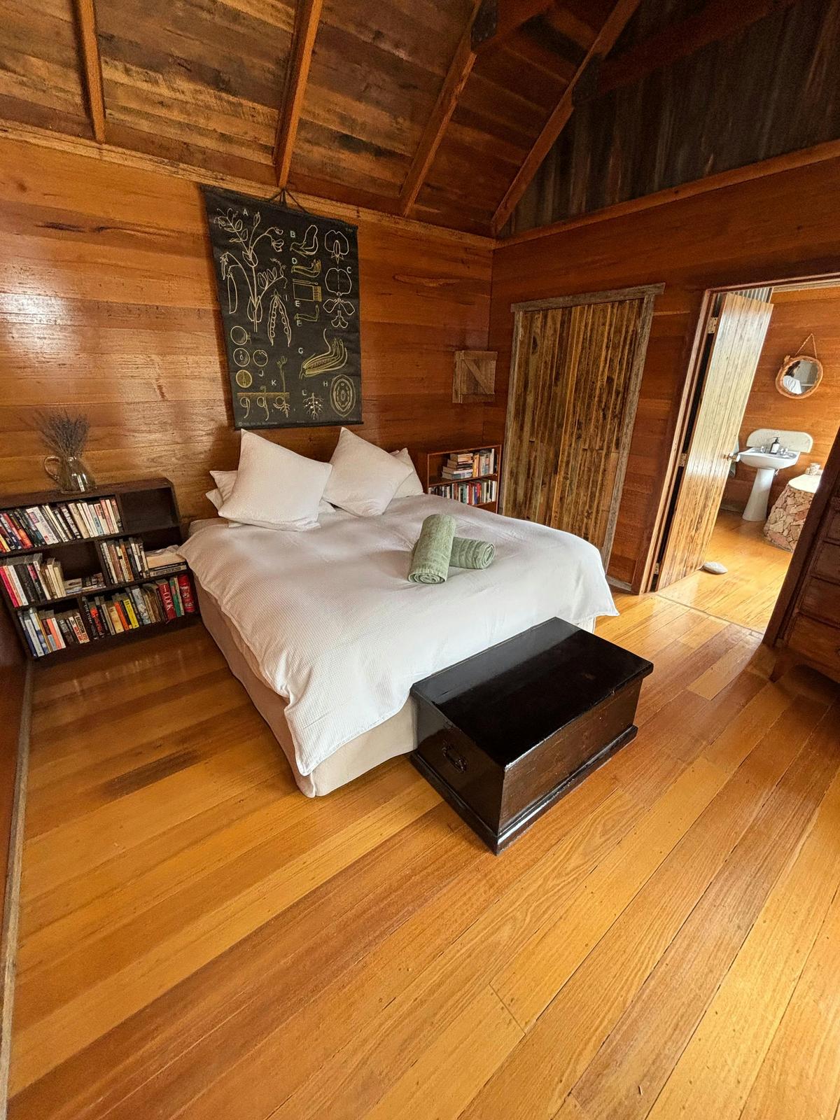 A luxurious super kingsized main bed fitted in fresh, bright white linen.