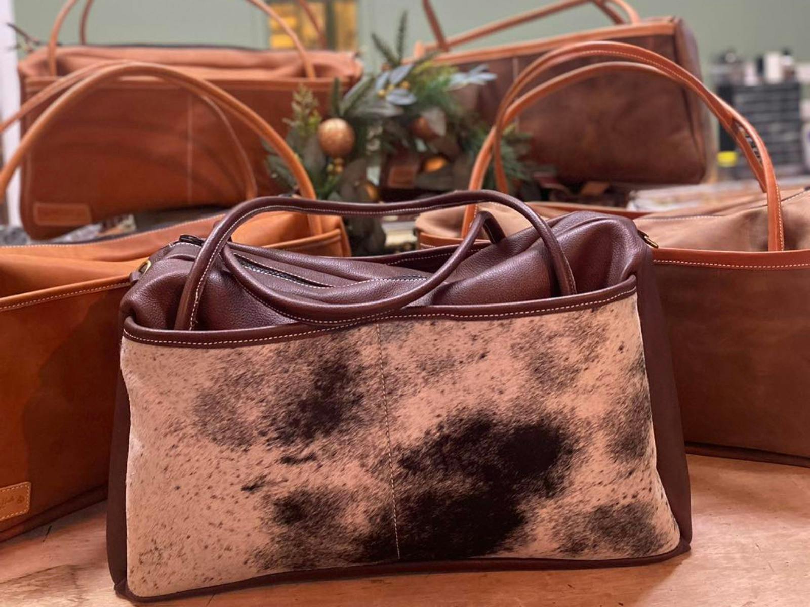 An assortment of leather duffle bags by Matilda Made Leather