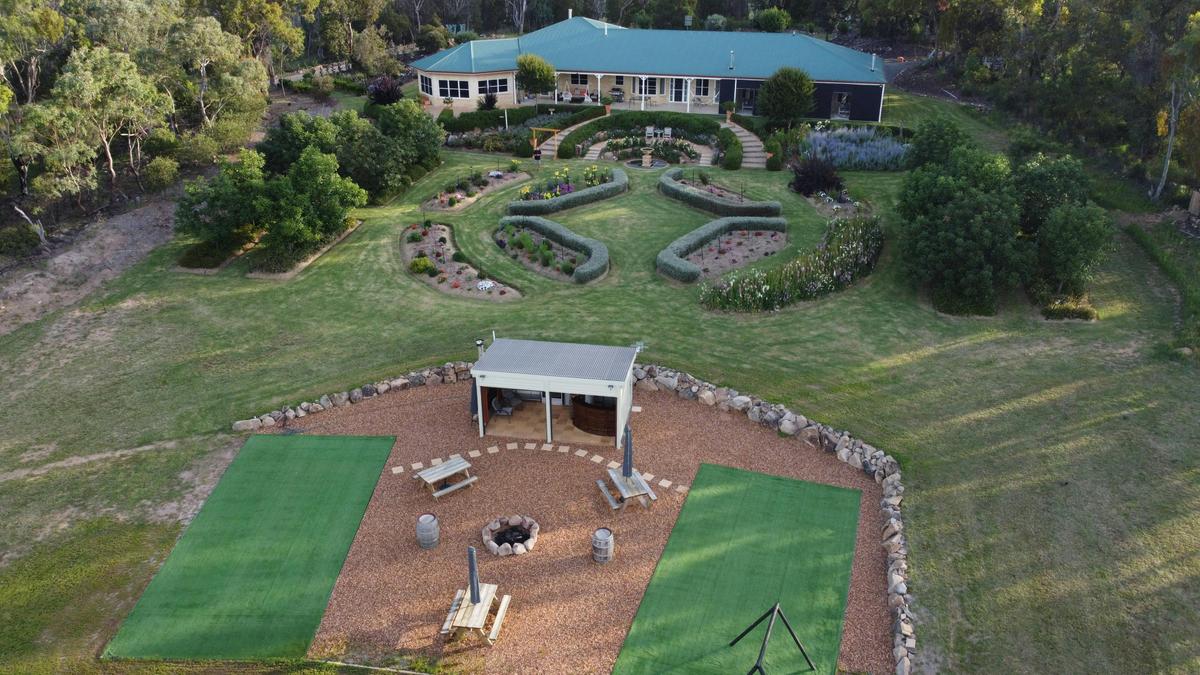 Outdoor Kitchen, fire pit badminton courts with suites in the background