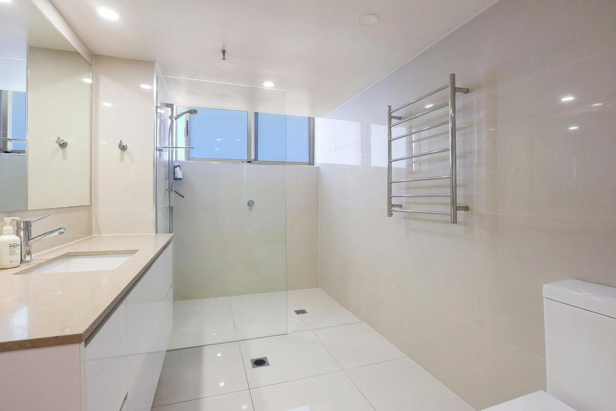Shared bathroom with washing machine and dryer - Peninsula Apartments Surfers Paradise Gold Coast