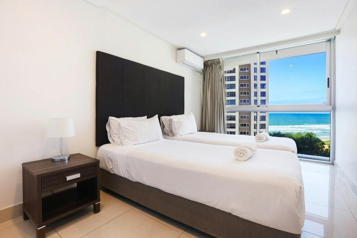 Second bedroom with 2 single beds, ocean views, tile floors - Gold Coast Holidays Surfers Paradise