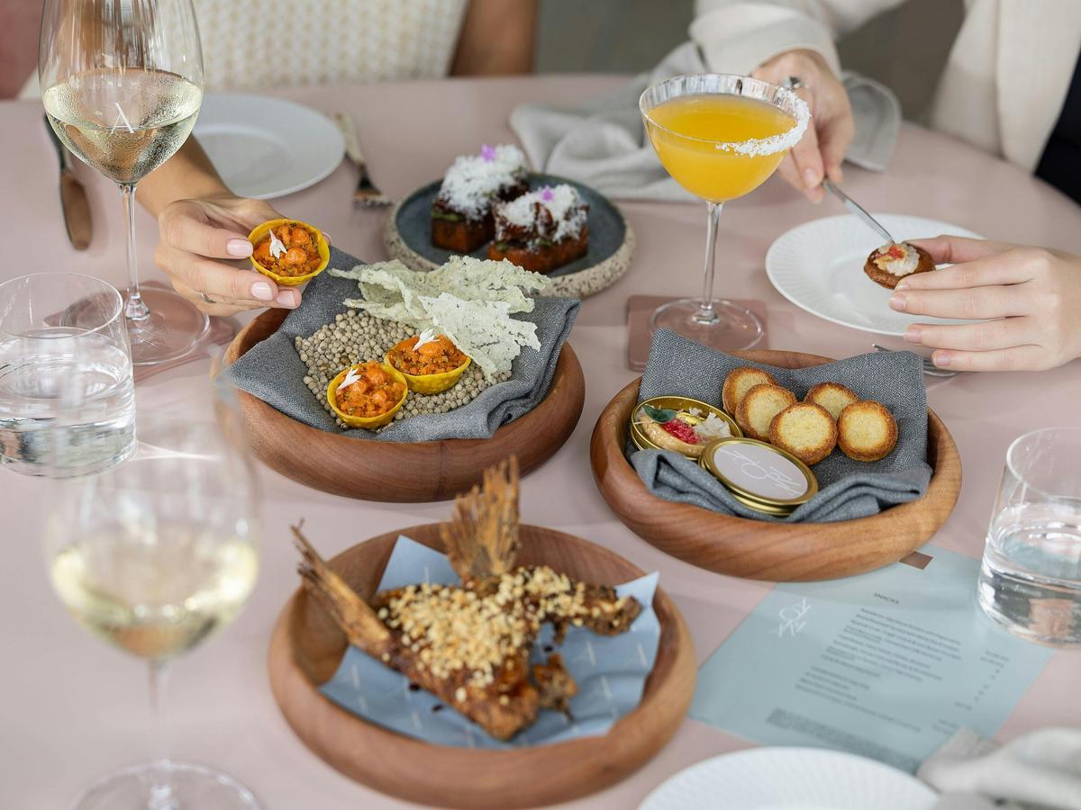 Plates of snacks and cocktails at Aloria