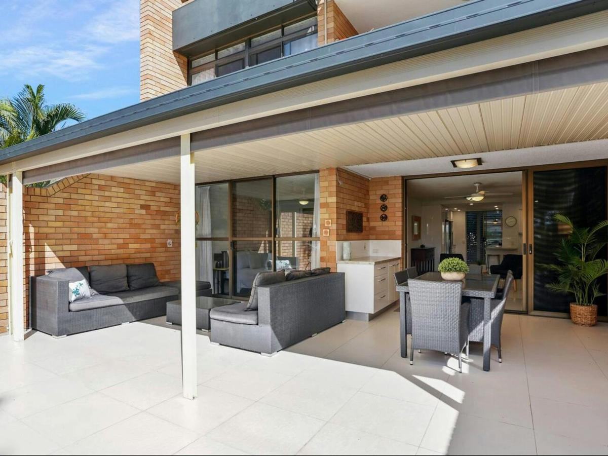 Large balcony space with outdoor lounge and dining