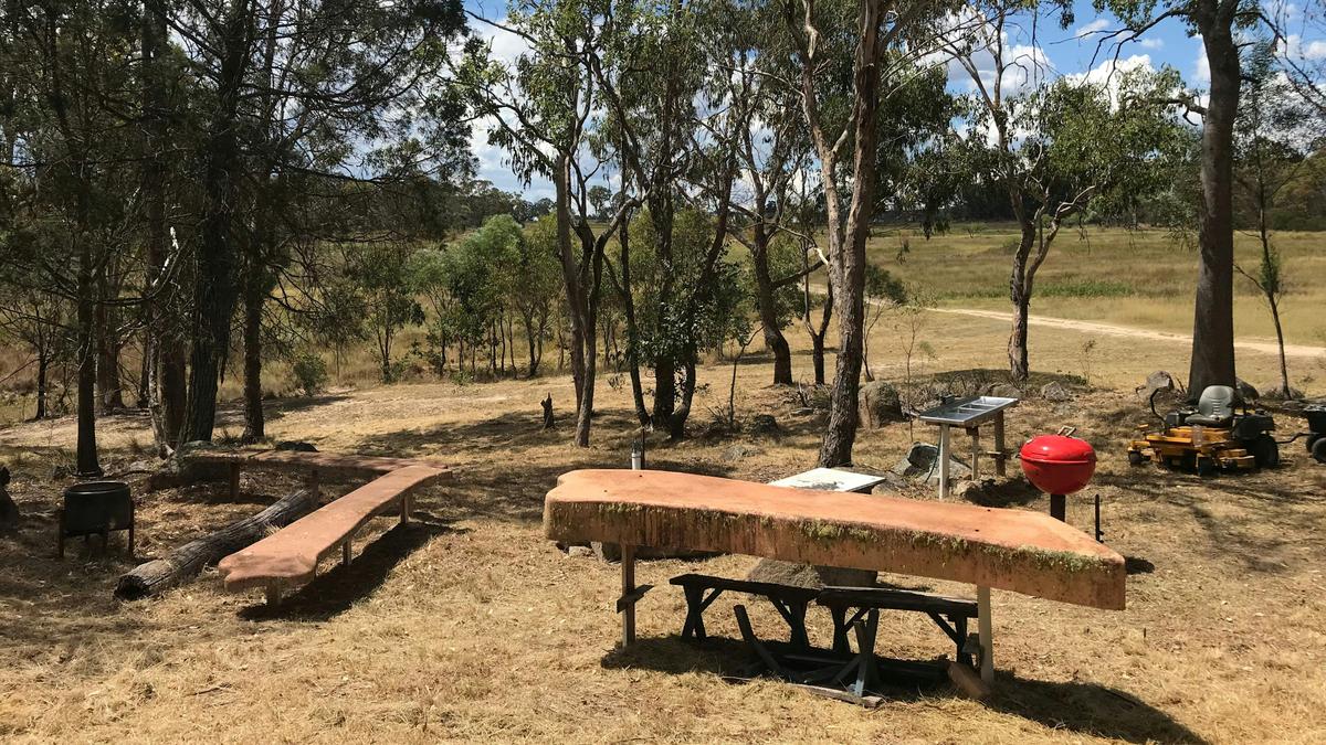 Site 1: Outdoor cooking area, fire drum and seating benches, wood BBQ, stainless steel sink with running non-potable dam water mains tap.