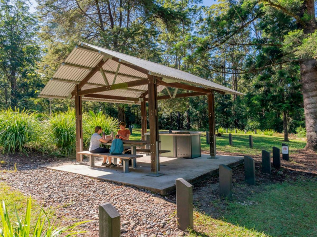 Campers sitting at the picnic shelter at Cutters Camp campground. Credit: John Spencer &copy; DPE