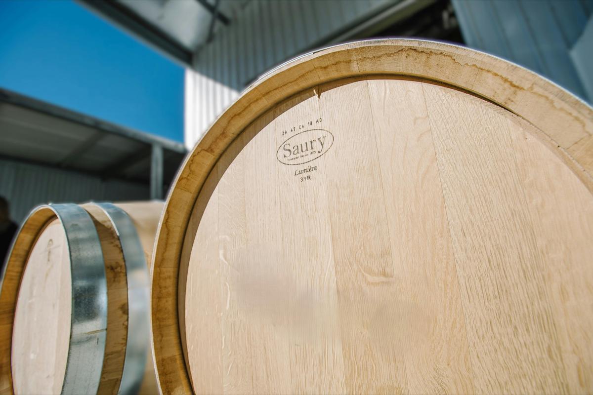 Oak wine barrel with steel hoops, used to mature and store wine.