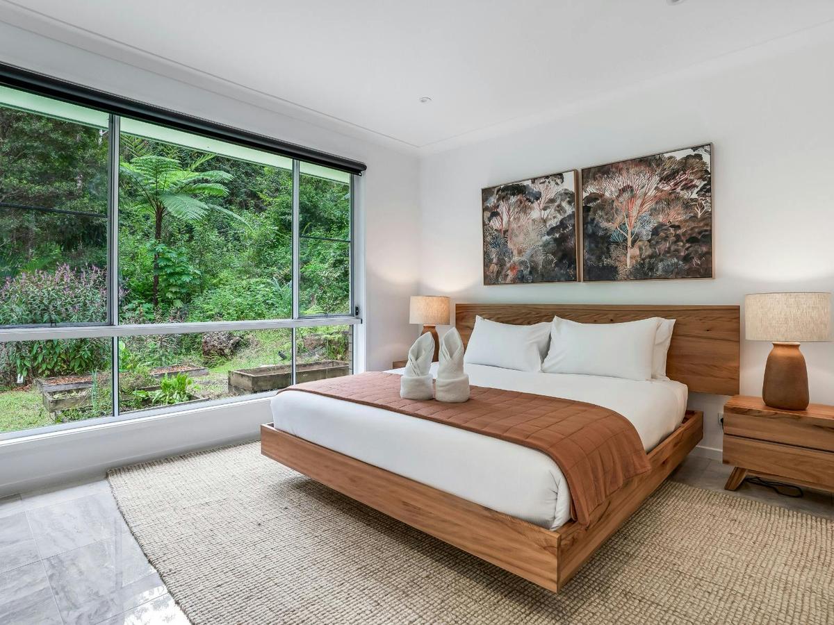 Main bedroom with ensuite bathroom and rainforest views