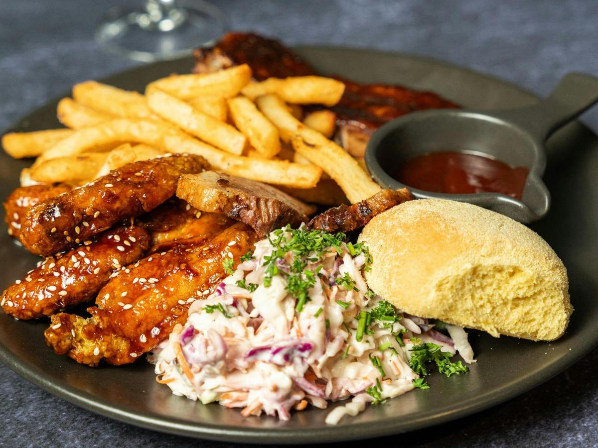 Brothers Carnivore plate with brisket, wings, ribs and slaw