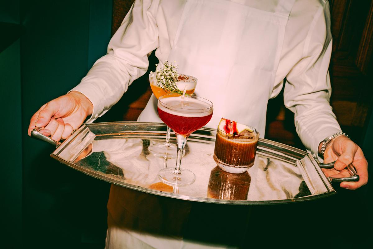 A silver tray with two lovely cocktails on it