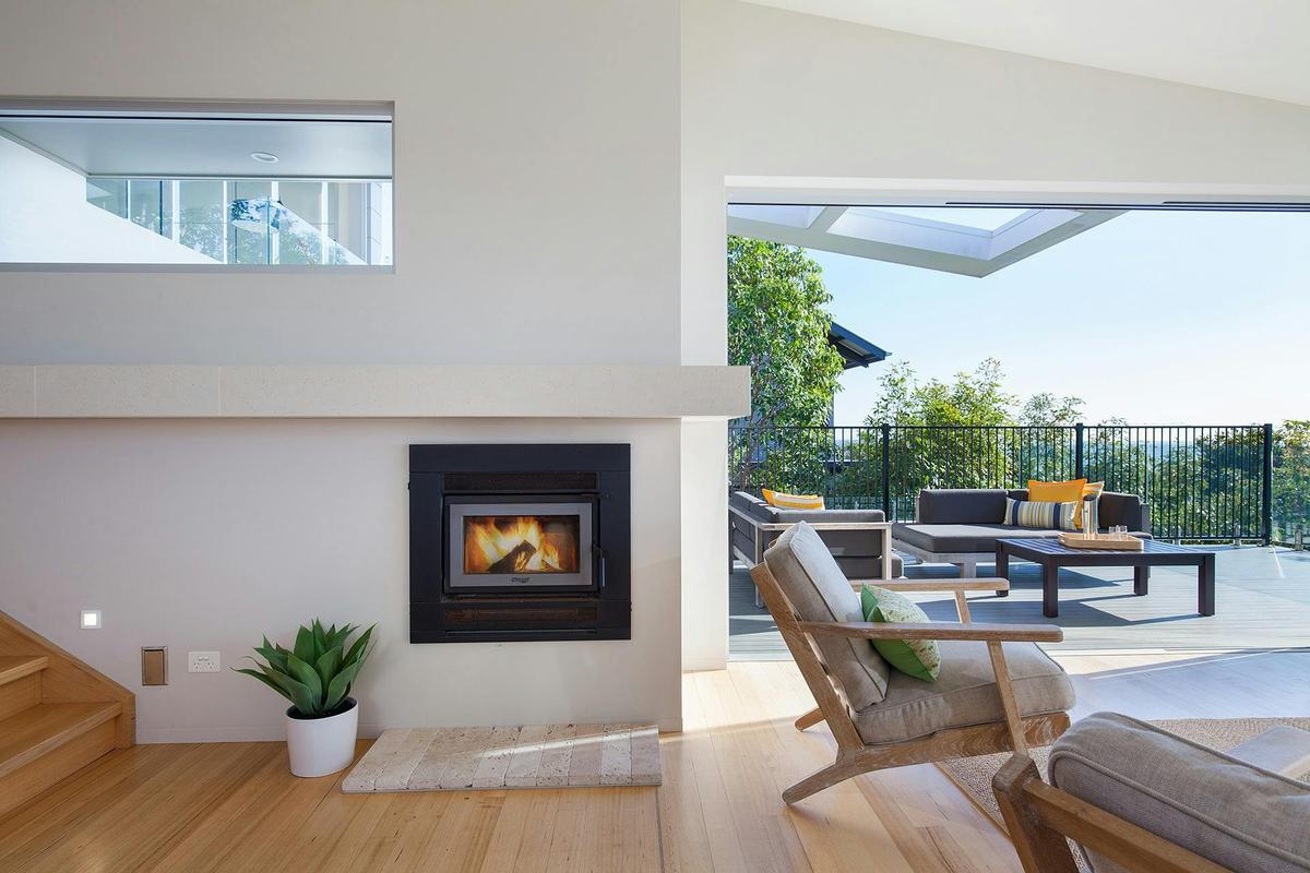 Large open stacking doors leading out to pool and outdoor entertaining with ocean views