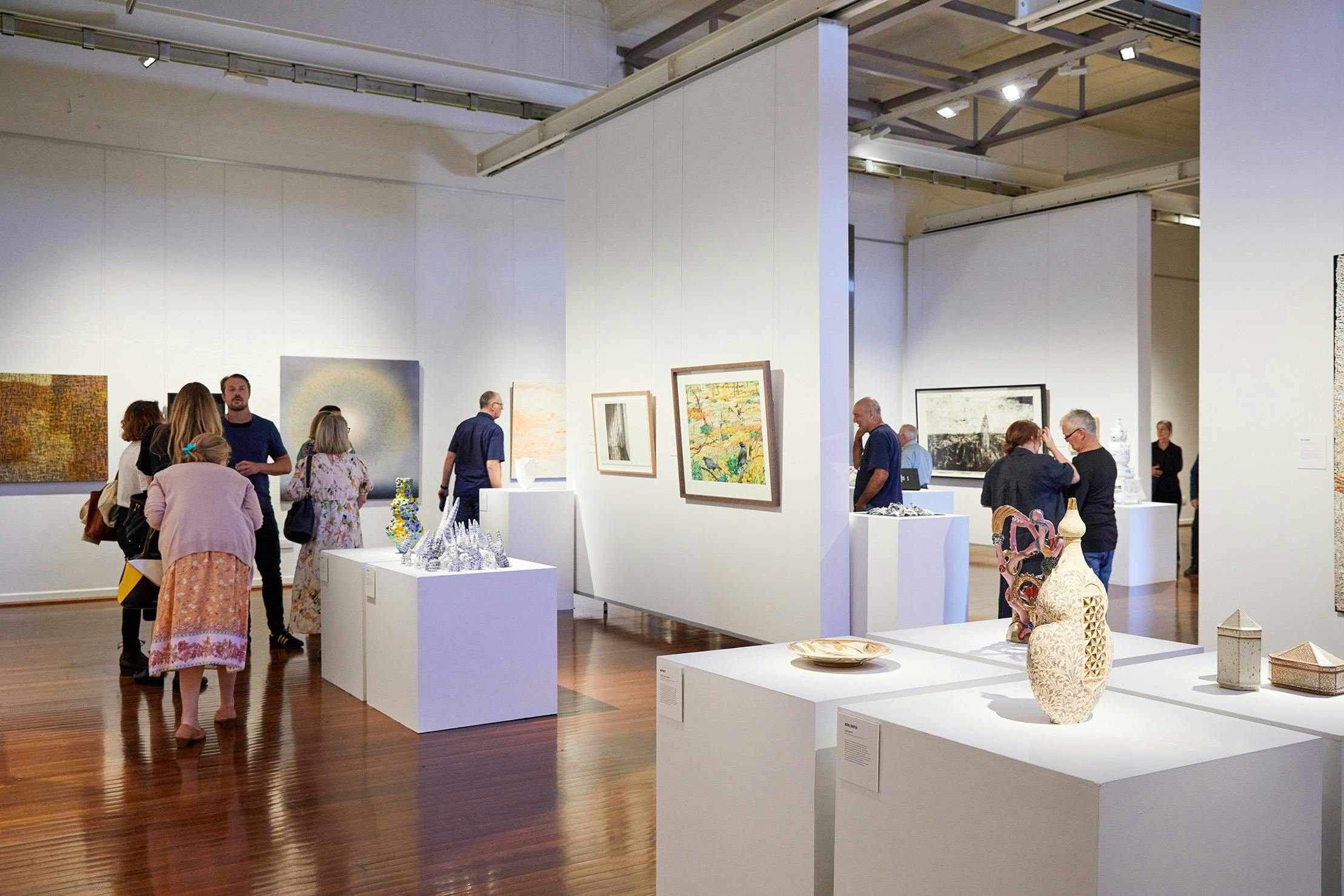 gallery space with people looking at artwork
