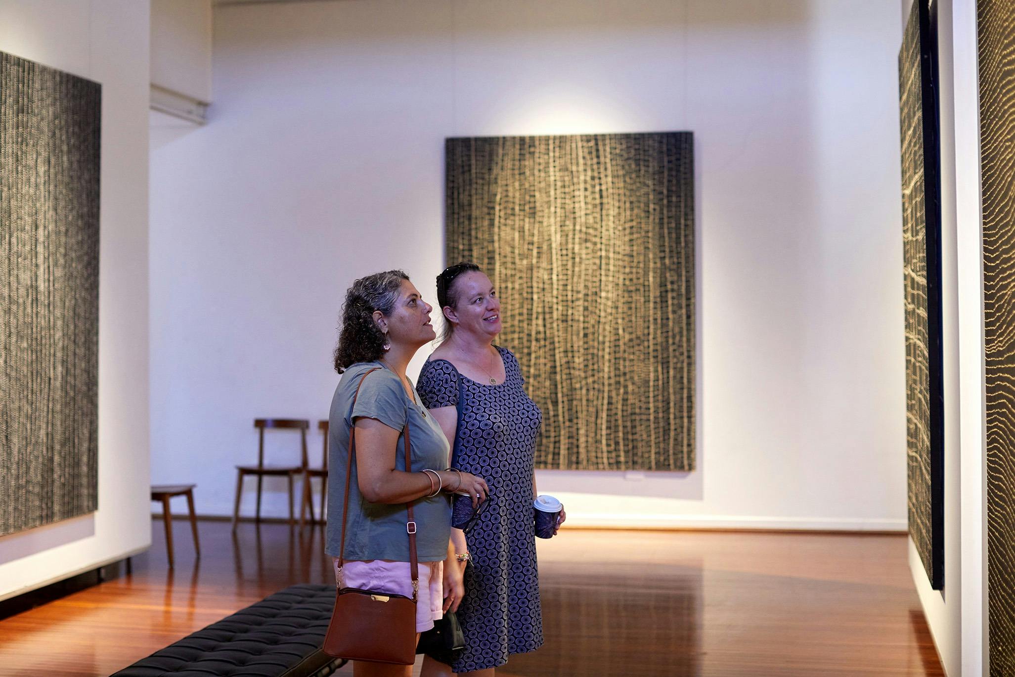 Two people looking at artwork