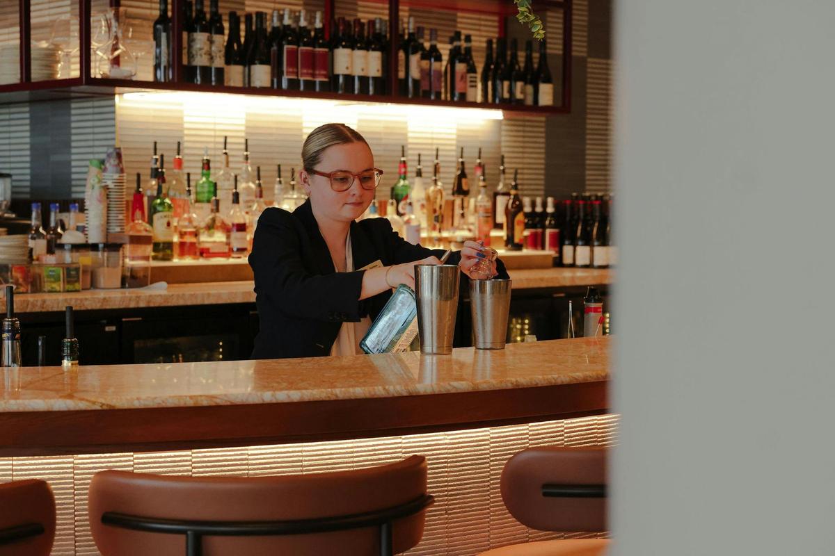 A bartender making a cocktail at Cucina Regina