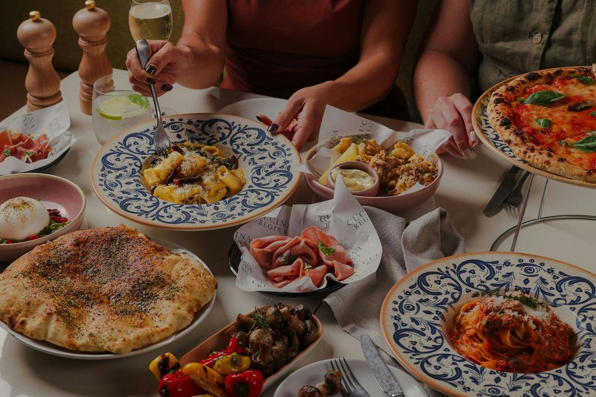 A table filled with Italian food at Cucina Regina