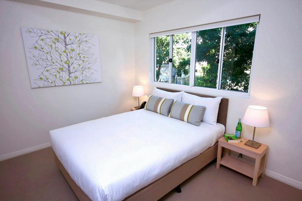Light-filled queen bedroom with garden views