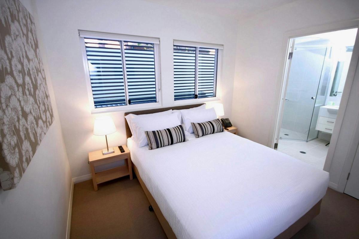 Master bedroom with ensuite bathroom in a serviced apartment