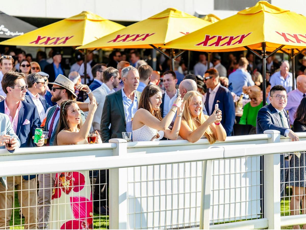 Patrons watching the races at Doomben Racecourse