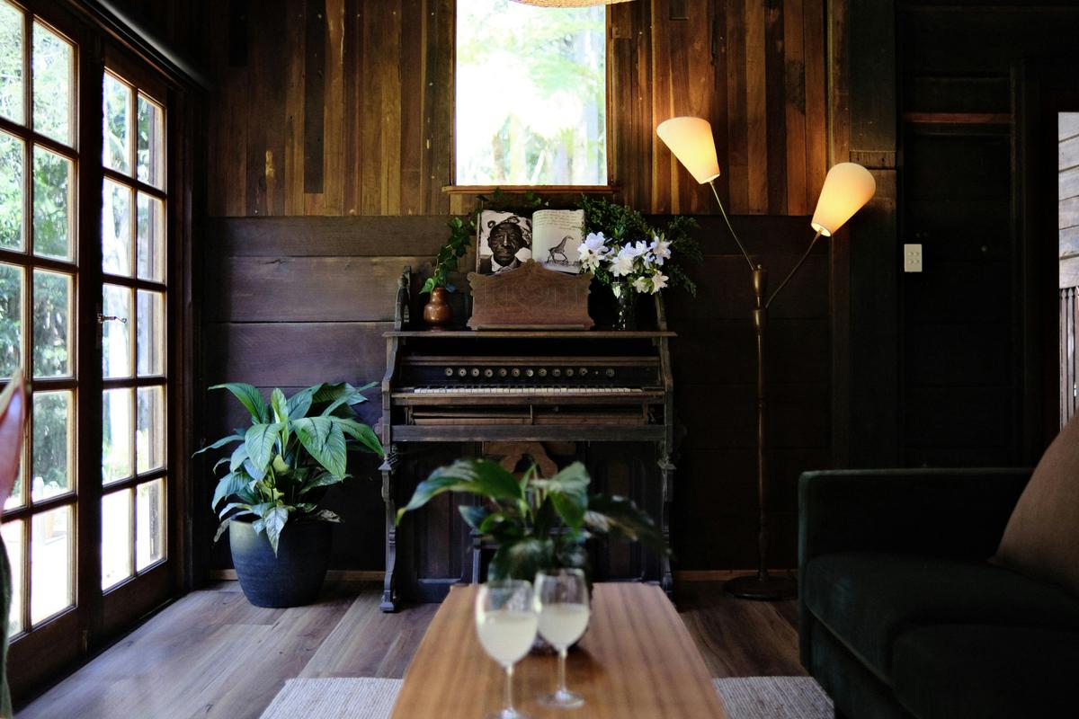 Elm House Downstairs lounge overlooking rainforest gardens through beautiful french doors