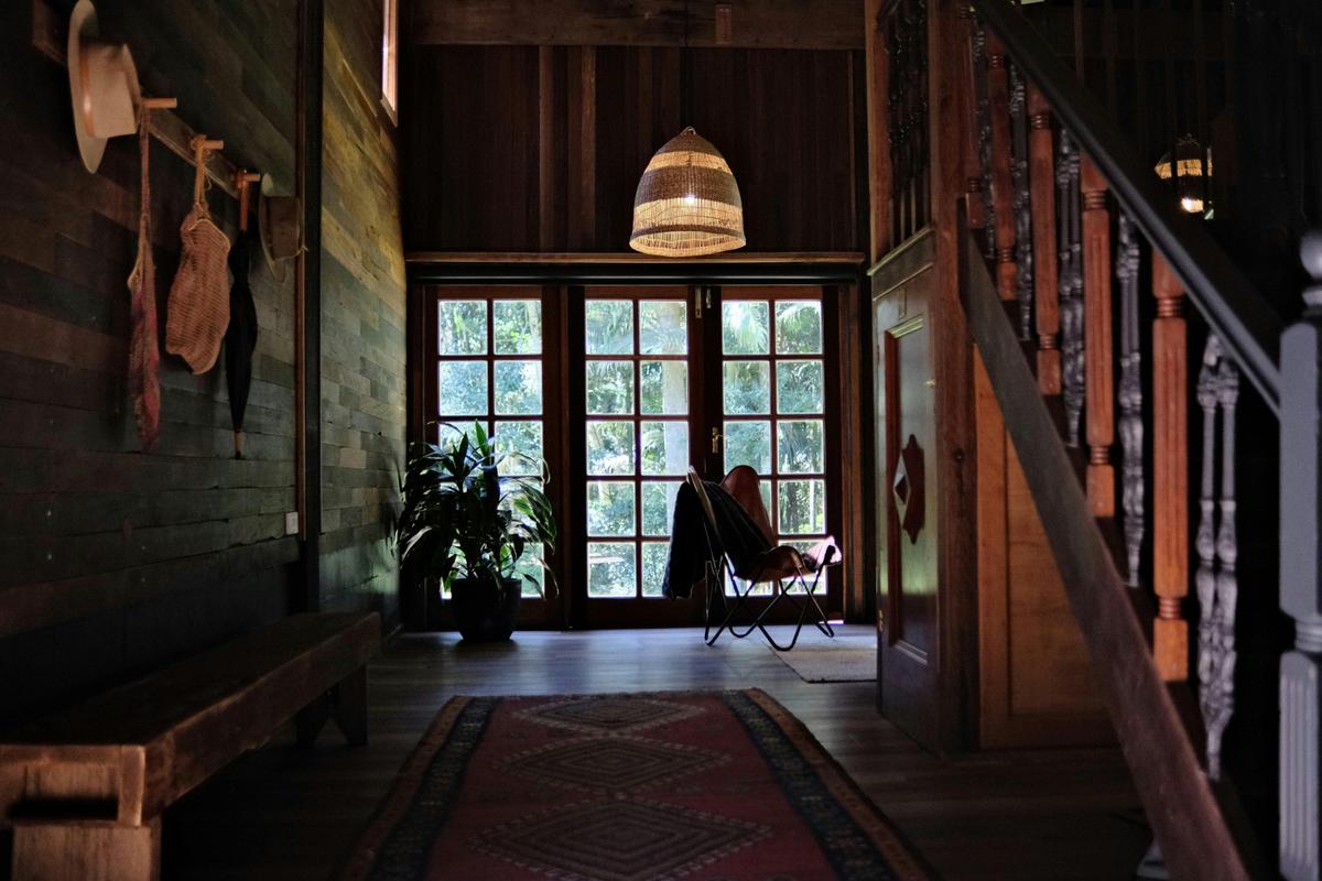 Elm House Studio Downstairs Lounging overlooking rainforest gardens through french doors