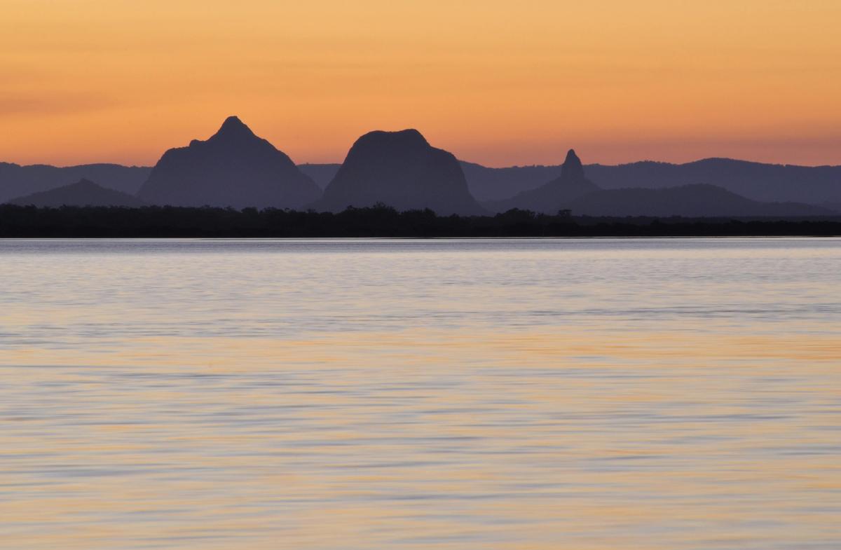 Sunset over the Glass House Mountains, viewed from the waters of Pumicestone Passage