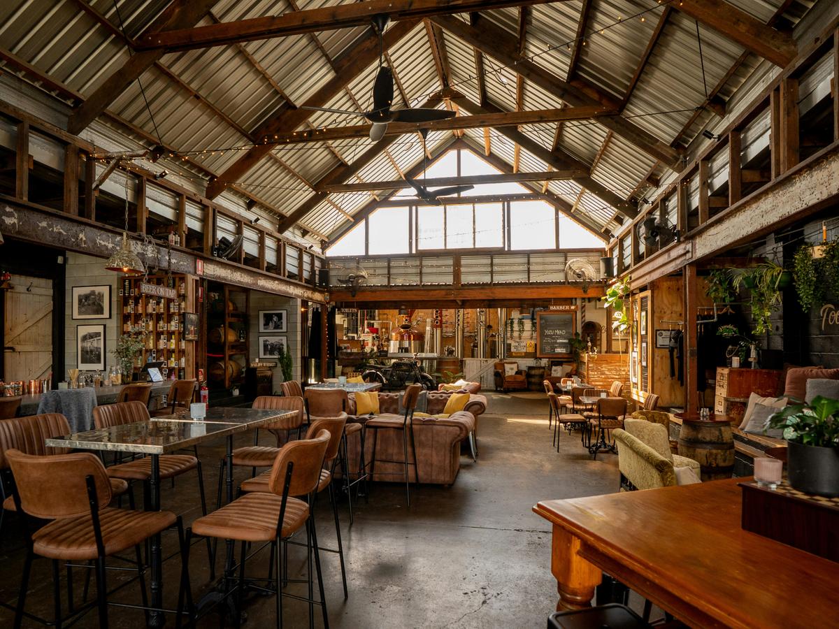 Exposed timber beams, industrial features, and relaxed seating before service begins.