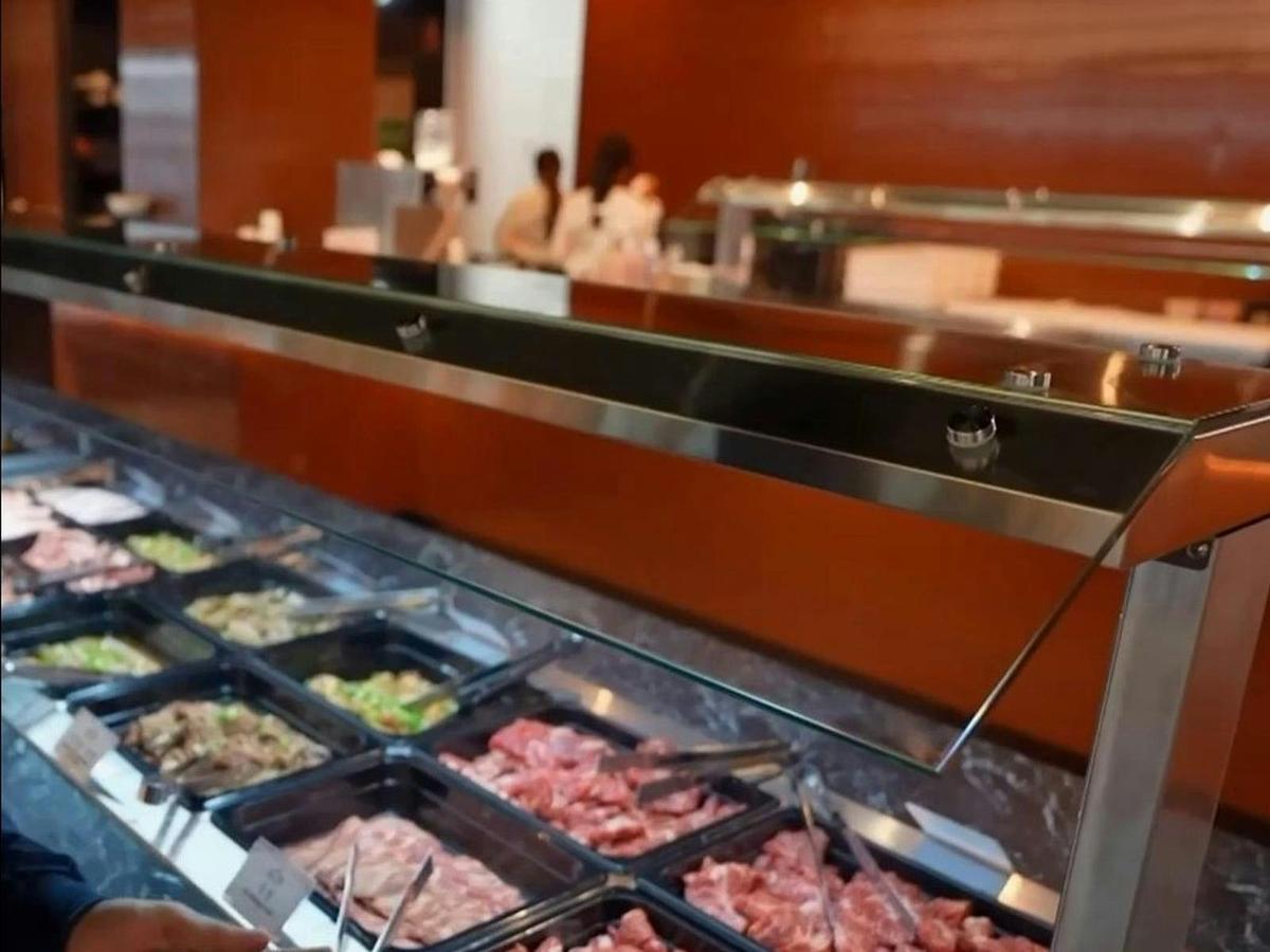 Selection of fresh sliced meats and marinated BBQ cuts at the buffet station