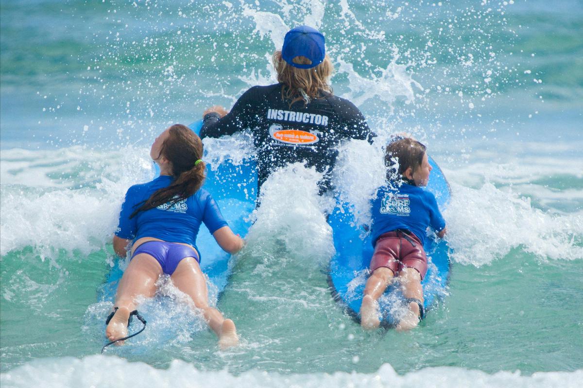 Surfgroms heading out to catch a wave