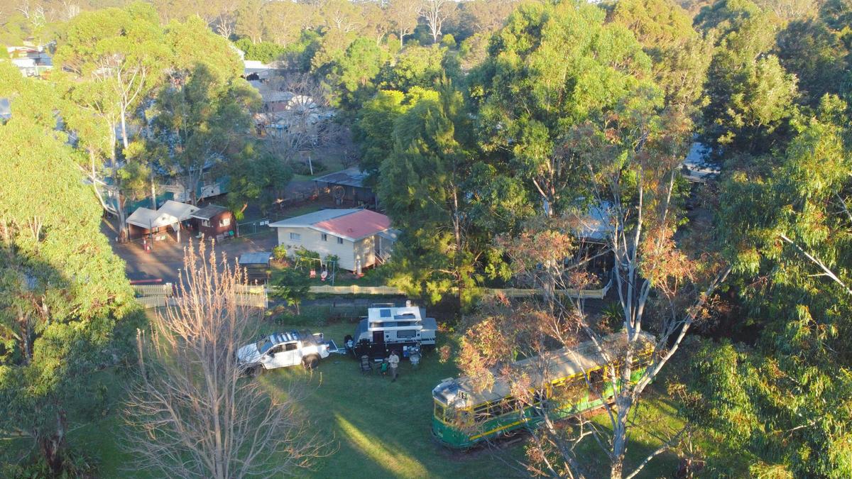 The campsite is leafy with manicured lawns and gardens.