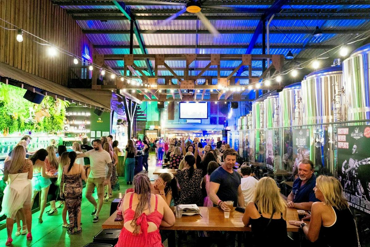 Industrial scale meets craft soul: the main floor featuring our bar and active brewhouse