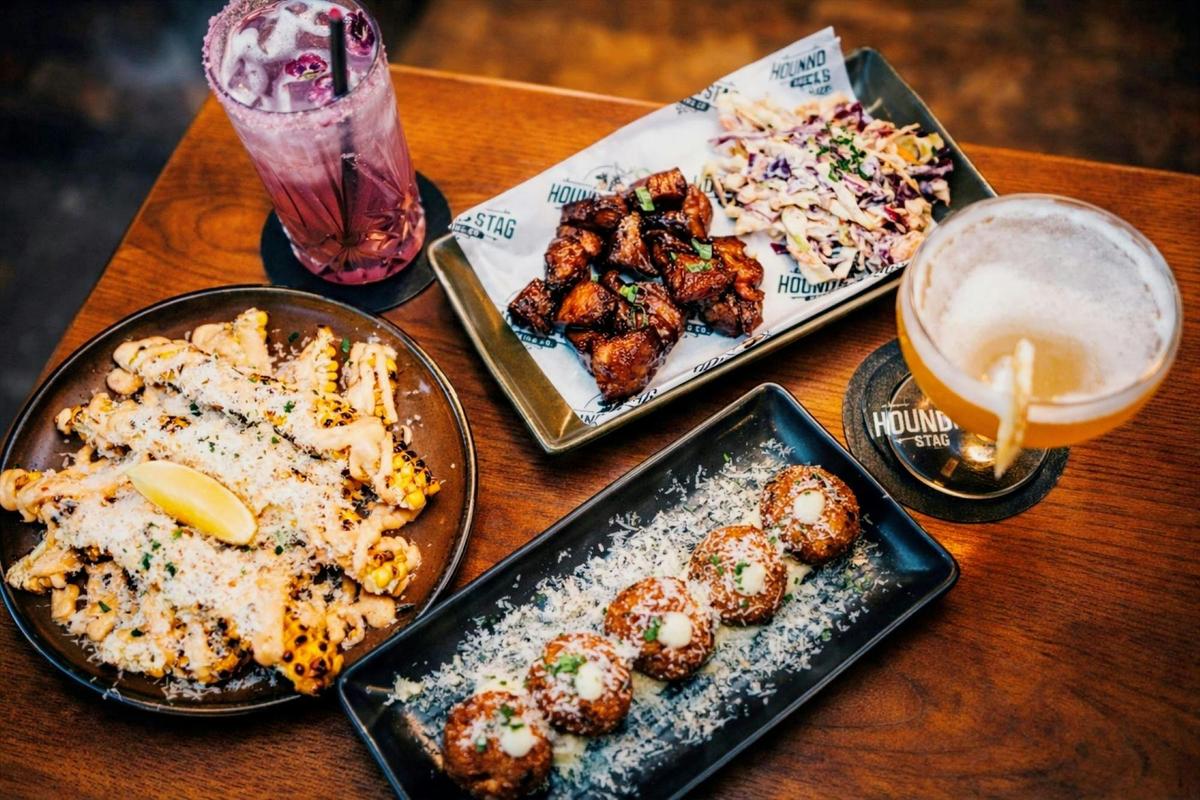 A vibrant spread featuring the signature shared plates and cocktails at Hound & Stag Brewing Co.