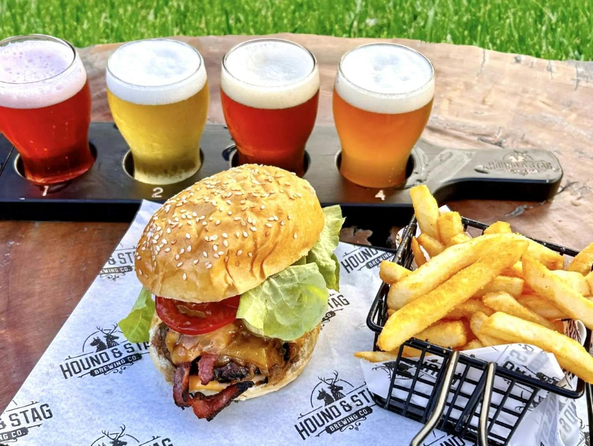 Sensory perfection: "The Hound" beef burger served with crispy fries and a craft beer tasting paddle