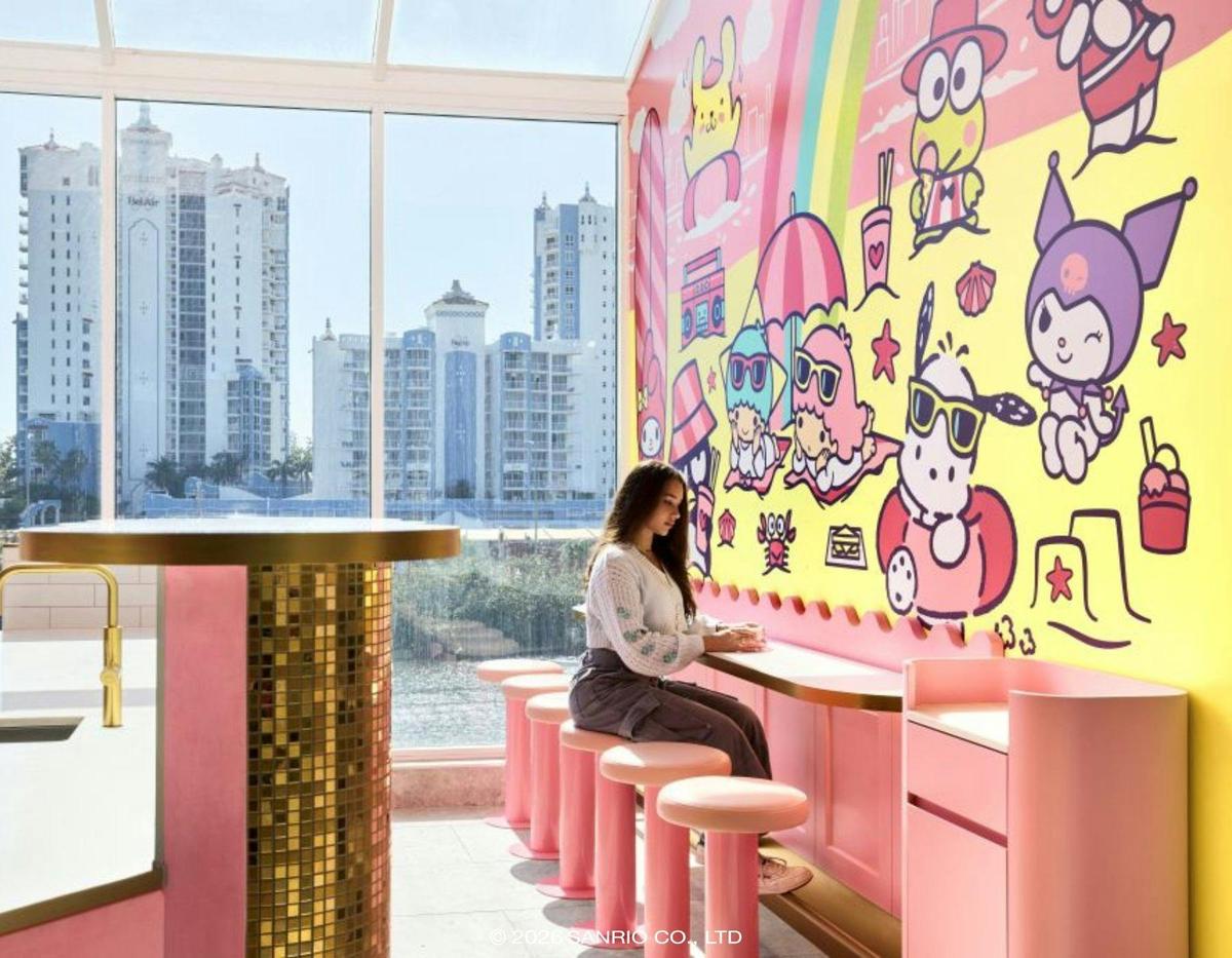 Customers at a pink service counter with Sanrio characters in the background.