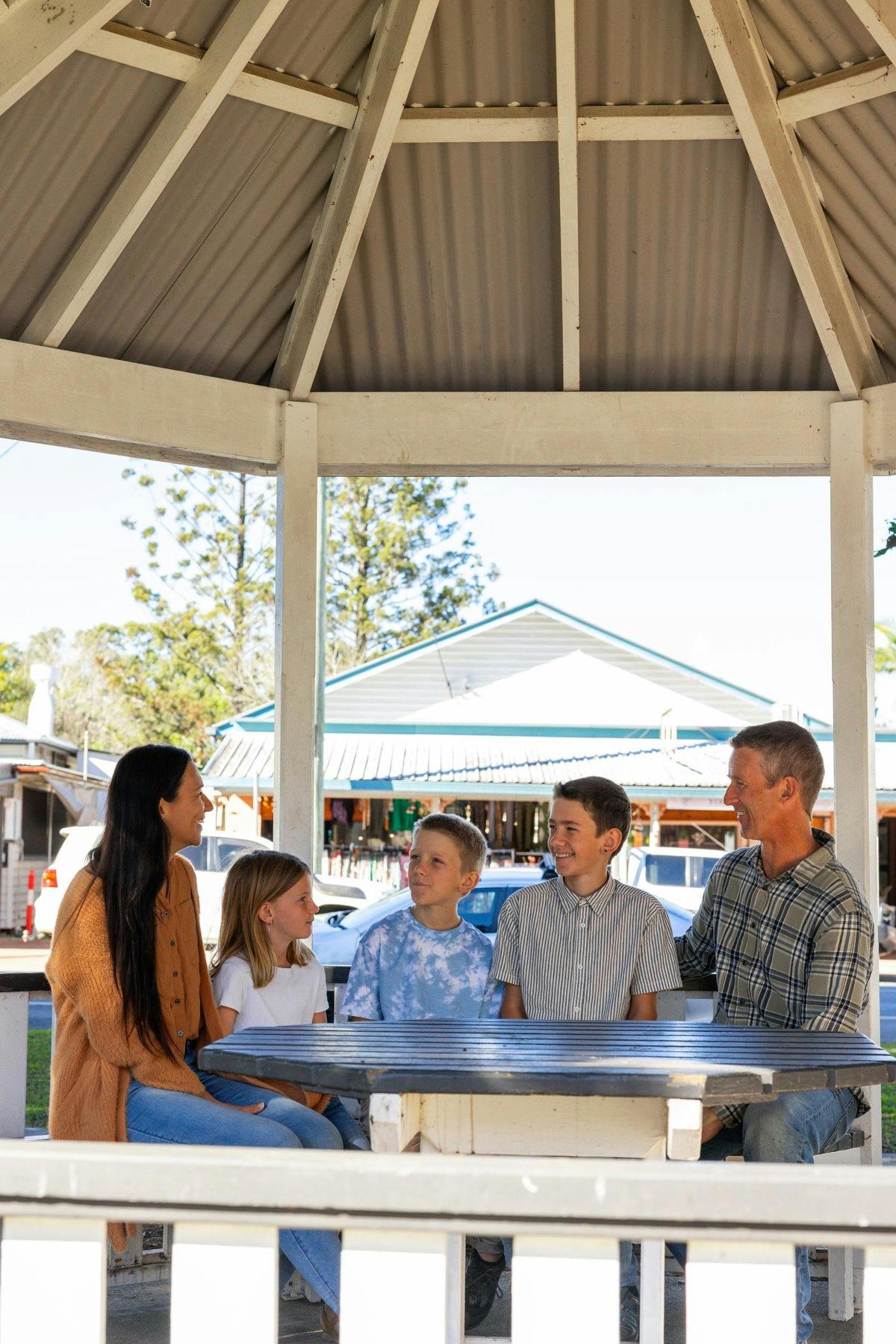 Family sitting at the rotunda in the middle of town