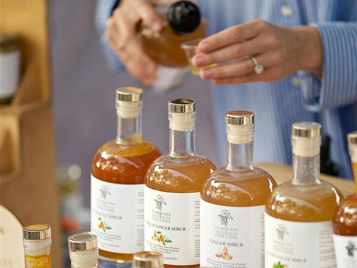 Home made cumquat syrup being poured by the maker at the market