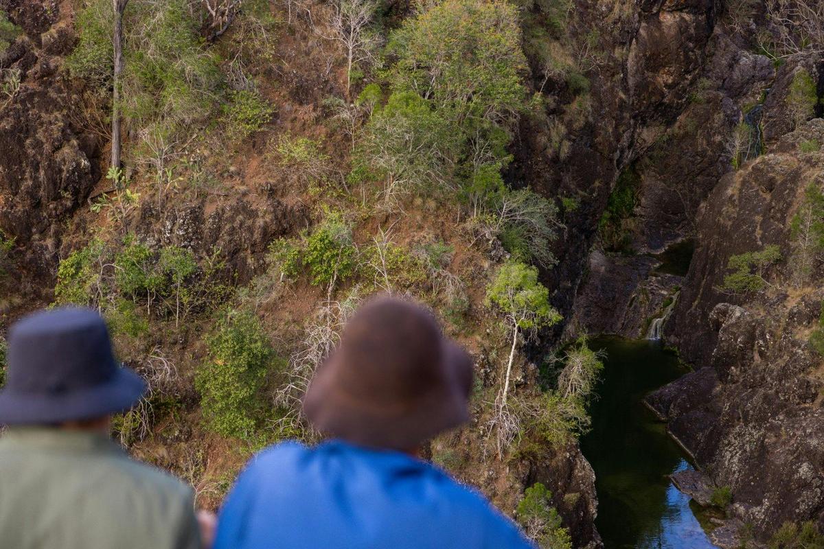 Aerial view of people looking down at kinbombi falls from the lookout
