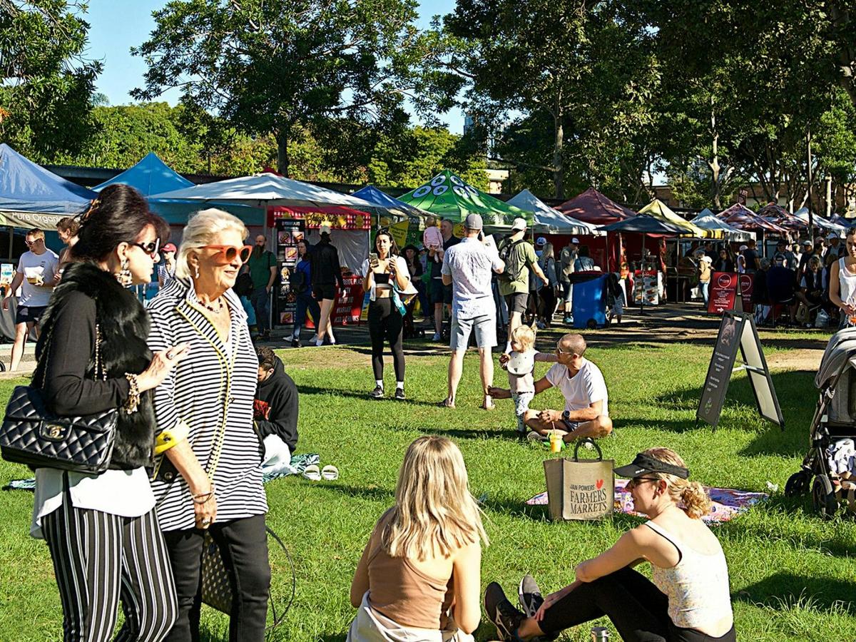 People enjoying the market sitting on the lawn