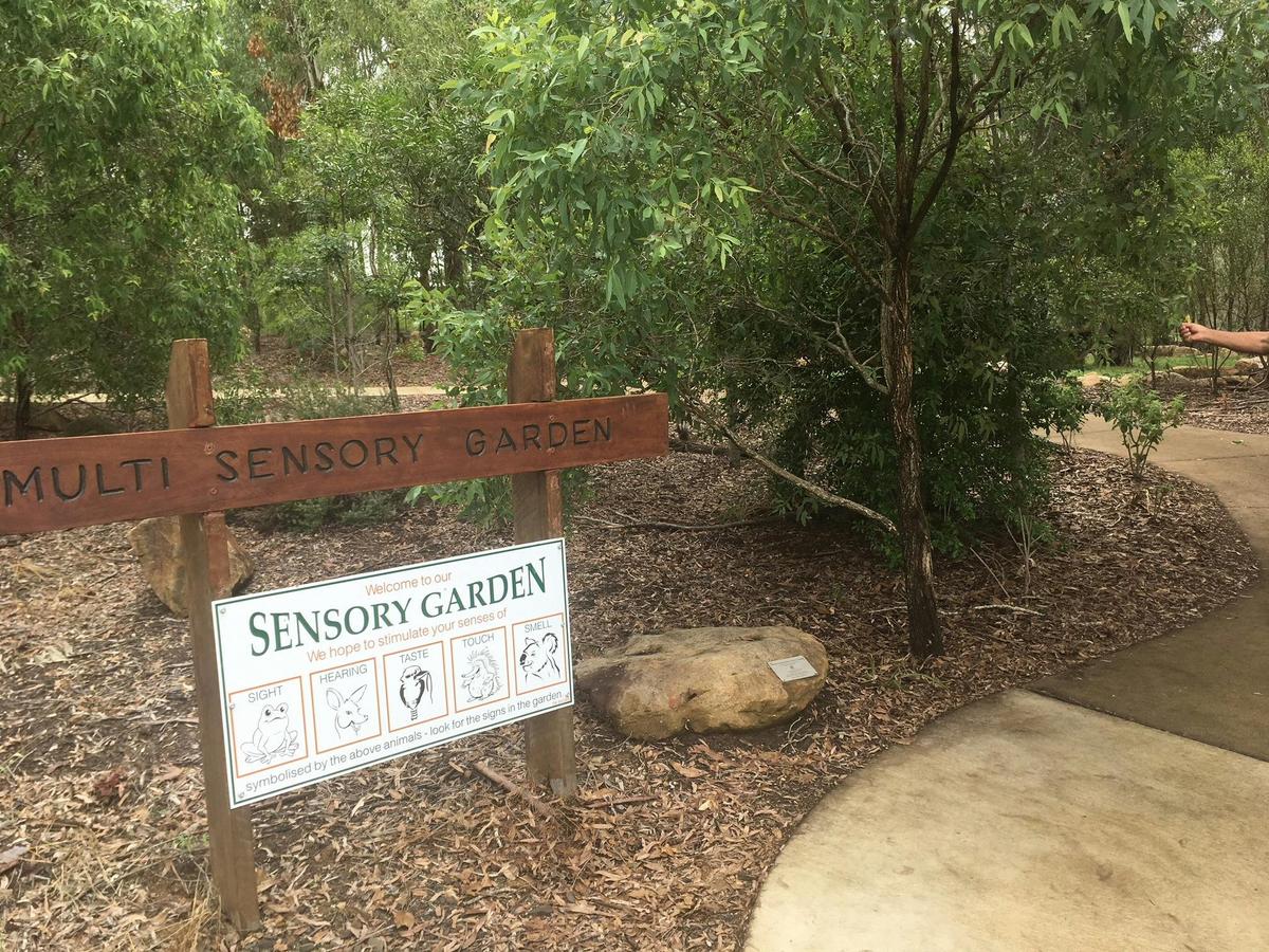 Park reserve with a sign indicating a sensory garden area