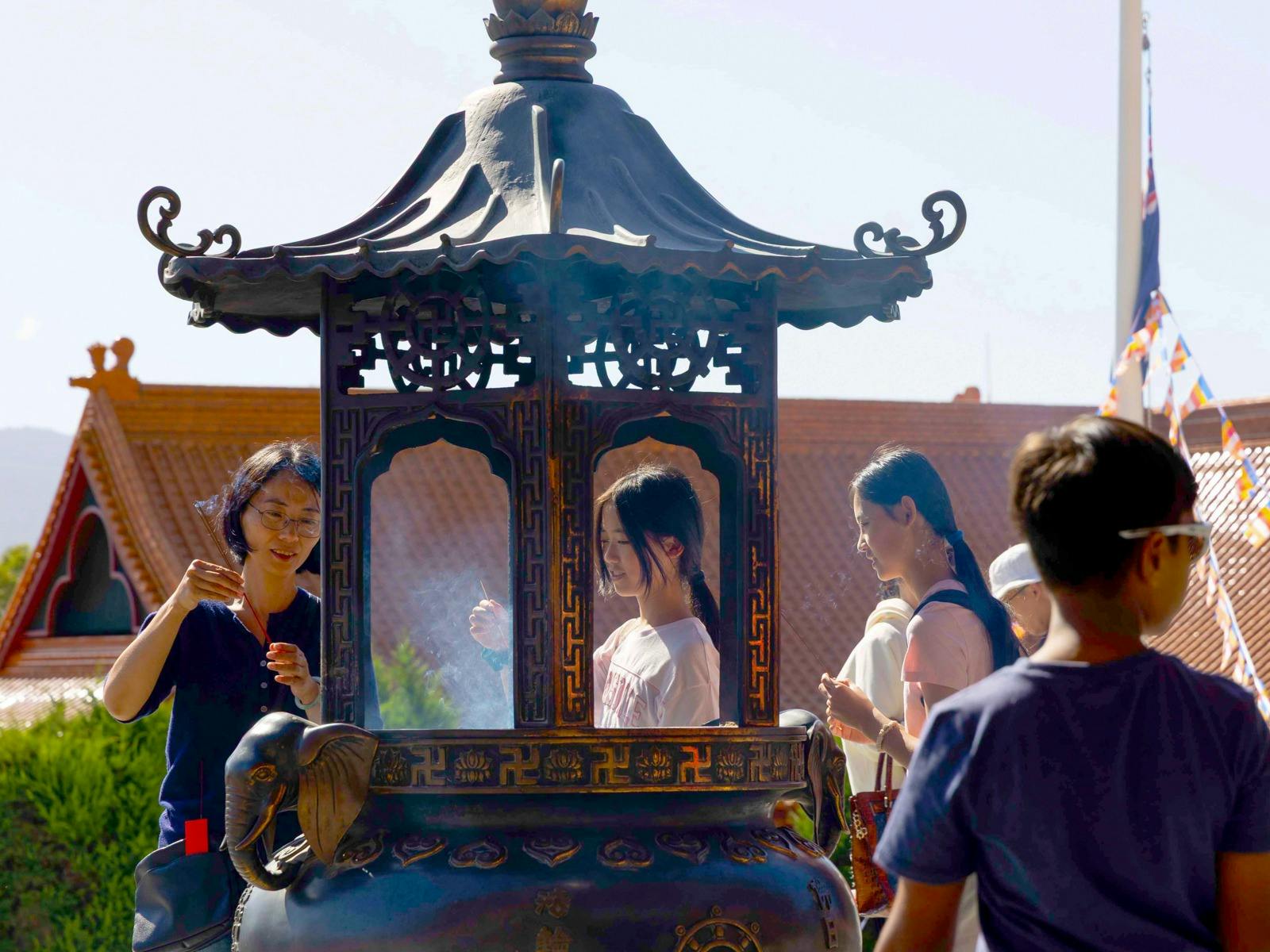Visitors making incense offerings at Nan Tien Temple