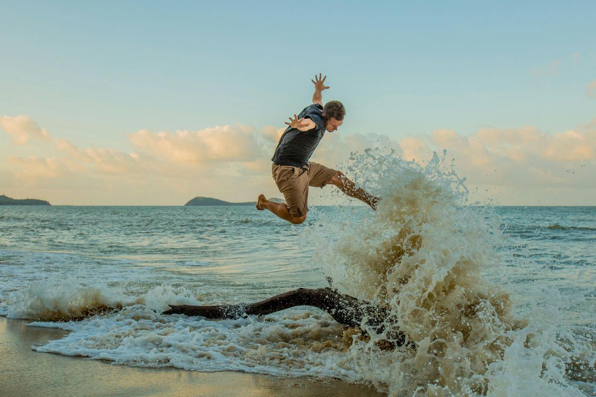 Jumping in the waves on Kewarra Beach
