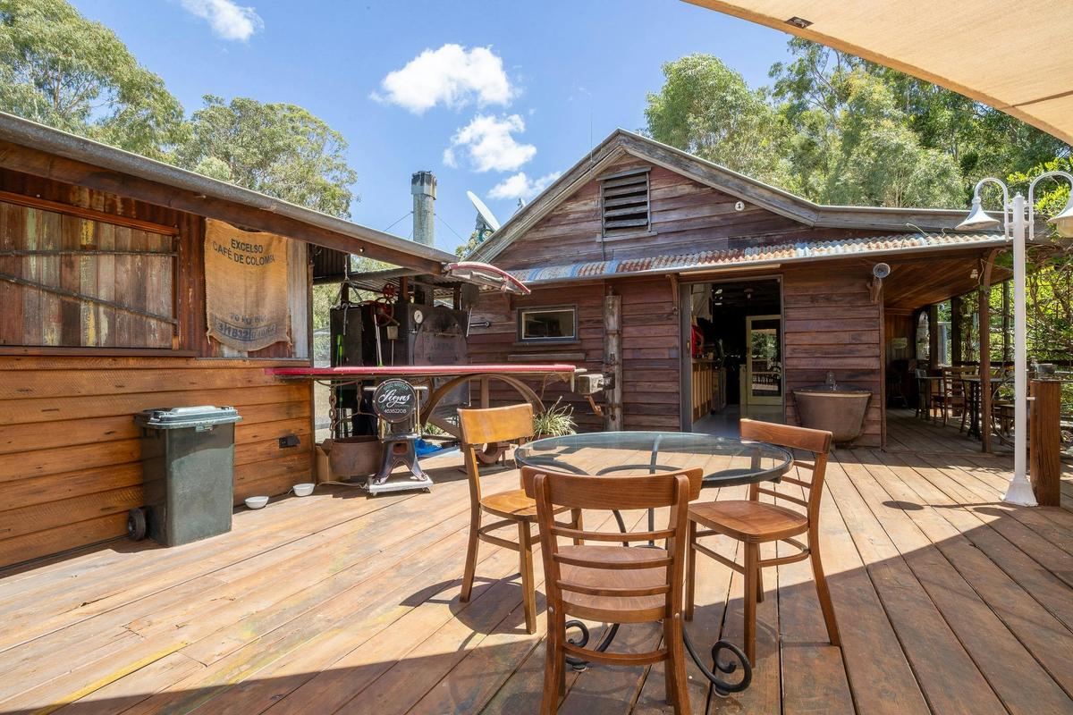 balcony seating with schoolhouse cafe in the background and industrial rustic style pizza oven